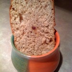 A slice ofOrange Raisin Whole Wheat Bread in an orange and green pot