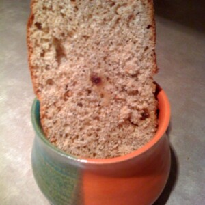 A slice ofOrange Raisin Whole Wheat Bread in an orange and green pot