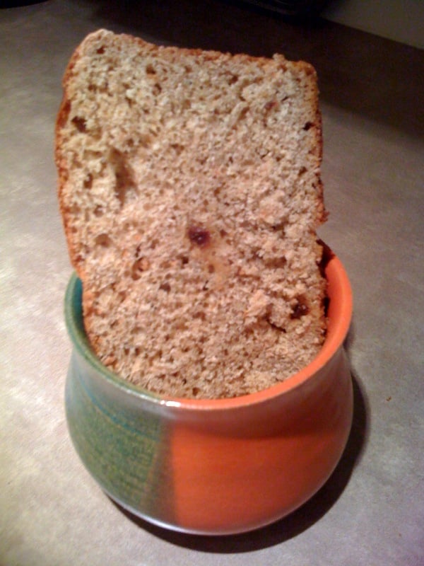 A slice ofOrange Raisin Whole Wheat Bread in an orange and green pot