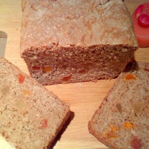 Slices of oat wheat bread on a wooden cutting board