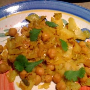 Patta Gobi Chole served on a blue patterned plate
