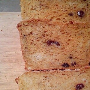 Slices of Carrot Ginger Raisin Bread on a wooden cutting board