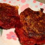 Two beet and potato cutlets on a pink and white patterned plate