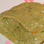 Cilantro garlic hummus on a white and pink patterned plate