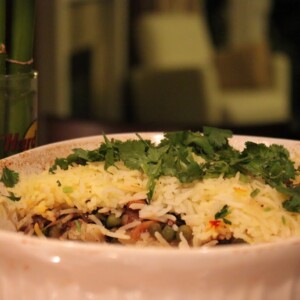 A 3 layer garlicky veg biryani in a deep white bowl