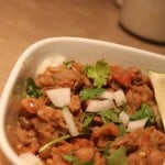 A bowl of everyday chole with a wedge of lemon
