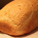 An olive oil sandwich loaf on a wooden chopping board
