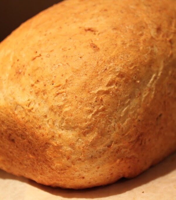 An olive oil sandwich loaf on a wooden chopping board