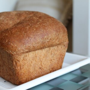 A loaf of mung sprouts wheat bread on a white plate