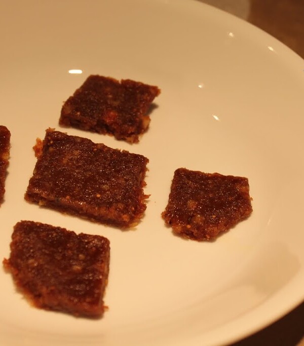 Squares of date fig burfi on a white plate