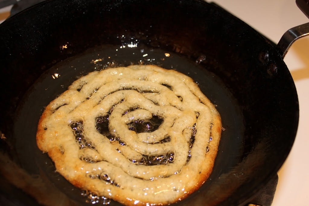 Vegan jalebi Recipe - Indian Sweet shaped like pretzels, deep fried and dipped in sugar syrup. Like a funnel cake.