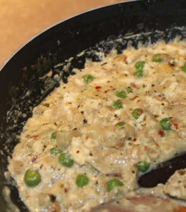 Paneer being cooked in a pan