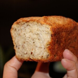 A pumpkin pie spiced oats and quinoa mini loaf being held towards the camera