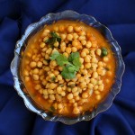 Imli chole served in a bowl on a dark blue background