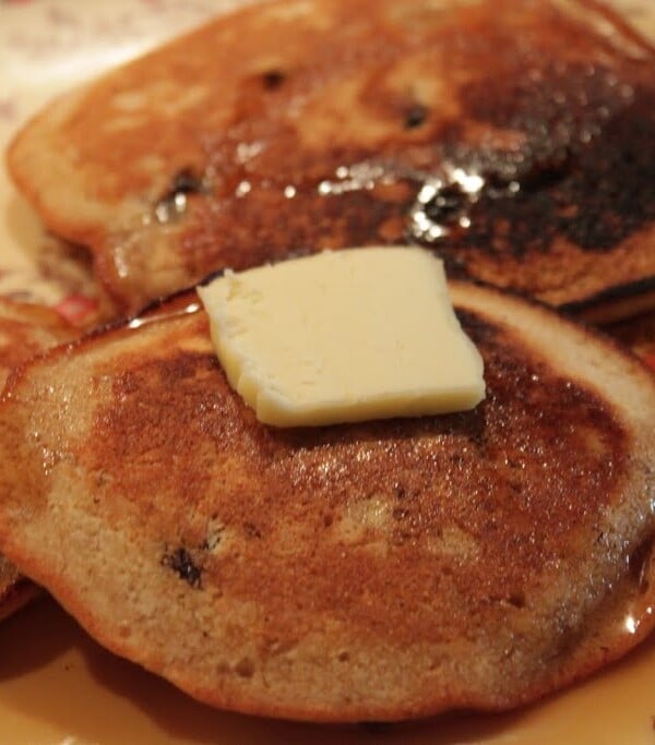 Ginger pancakes served on a white plate with a pat of butter