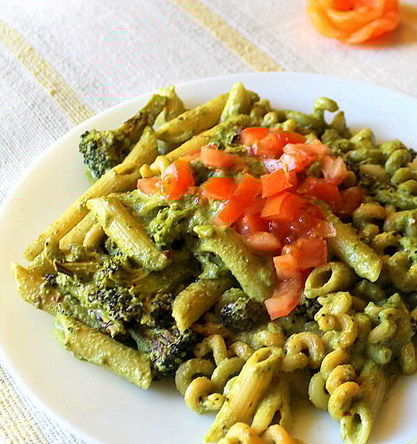 Basil cashew pesto with penne served on a white plate