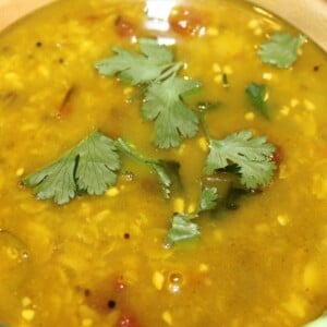 A close up of teen daal tadka garnished with cilantro