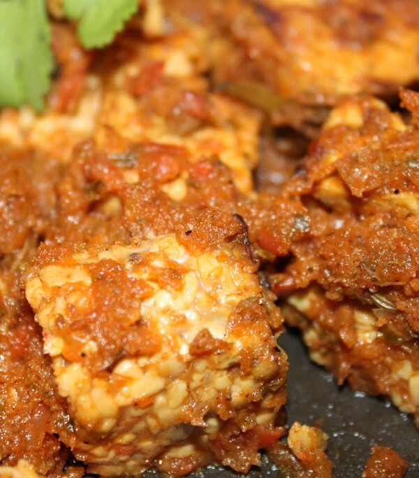 Dhania Fake Chicken served on a black plate with green garnish