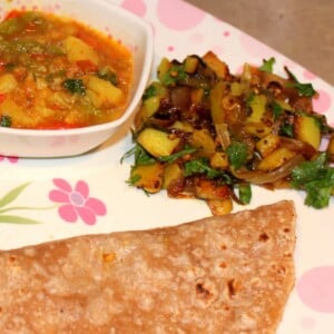 Aloo Pyaaz and Bhaji with Roti/Chapat served on a white and pink plate