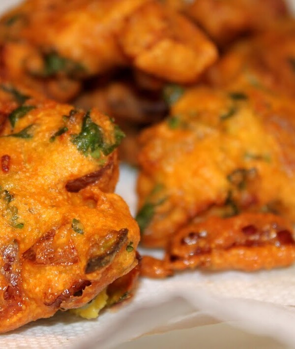 Onion fritters lying on some white parchment paper