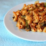 Red pepper alfredo sauce with pasta served on a white plate