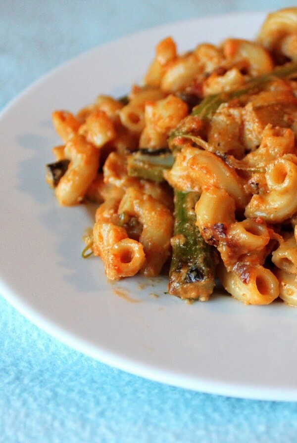 Red pepper alfredo sauce with pasta served on a white plate