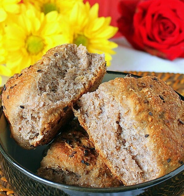 Strawberry cauliflower bread rolls in a dark blow with flowers in the background