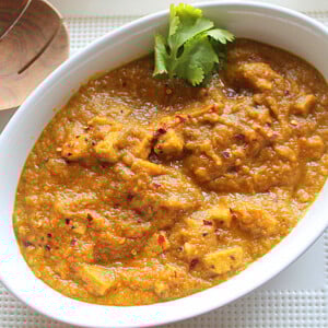 Mango curry tempeh in a white serving bowl