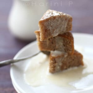 Pieces of gluten free carrot cake stacked on a white plate