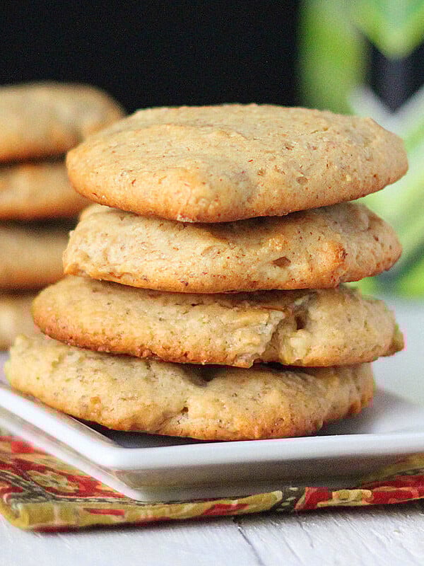 Coconut cookies stacked on a white plate