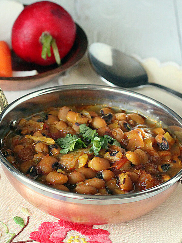 Black eyed peas curry served in a copper bowl with cilantro garnish