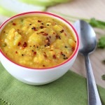 Pigeon pea soup in a white bowl on a green tablecloth