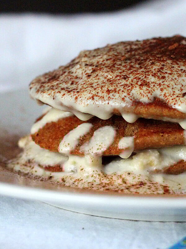 Vegan tiramisu pancakes stacked on a white plate