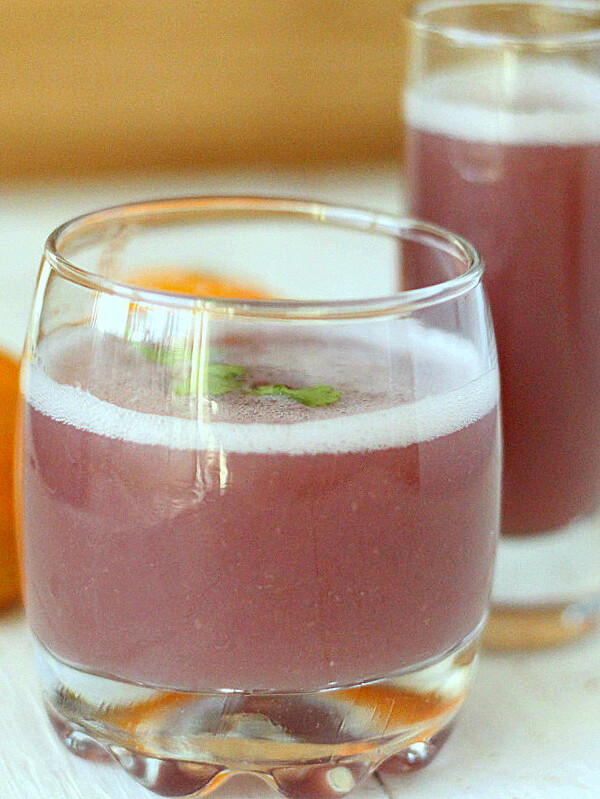 Pomegranate Apple Satsuma Spiced Cooler served in a small glass