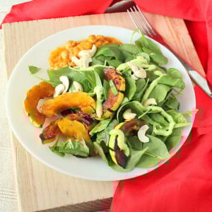 Maple Glazed Delicata Squash served on a white plate with salad