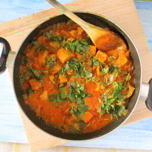 Kadai Gobi in a pan with a wooden spoon in it.