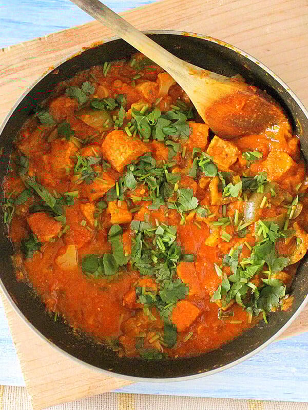 Kadai Gobi in a pan with a wooden spoon in it.
