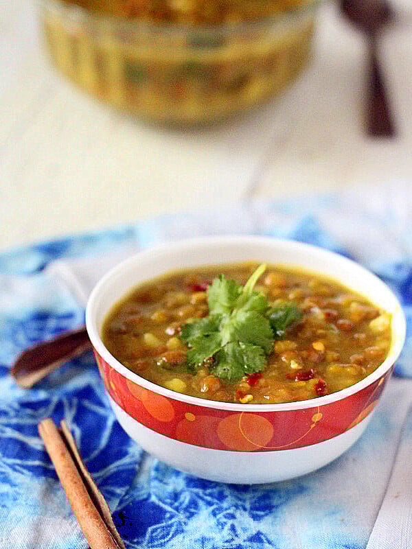 Mung bean daal soup served in a white and red bowl