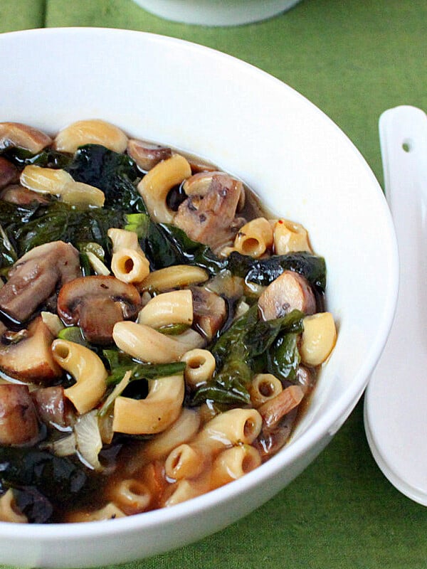 mushroom rainbow chard shallot soup served in a white bowl