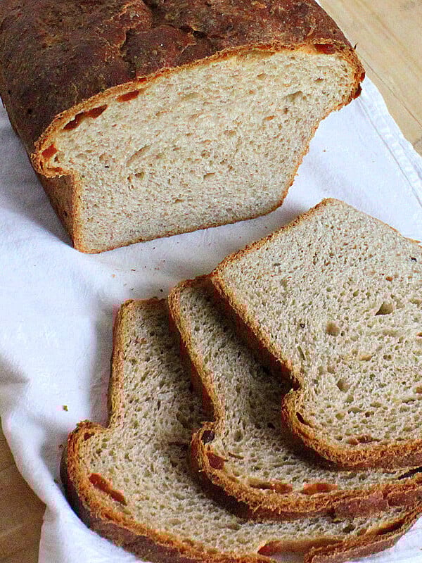 Grape multigrain bread on a white cloth cut into slices
