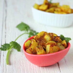 Panch Phoran served in a small pink bowl with cilantro garnish