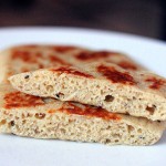 A close up of vegan gluten free naan cut in half