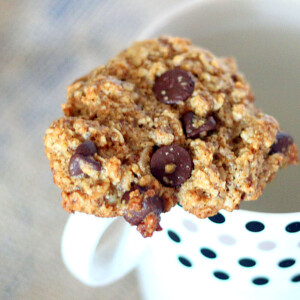 Oatmeal chocolate chip cookie resting on a mug