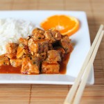 General Tso's tempeh served on a white plate with rice