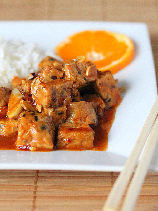 General Tso's tempeh served on a white plate with rice