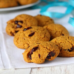 Six muffin top cookies on some white fabric with a blue ribbon in the background