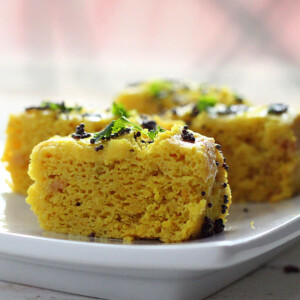 Khaman dhokla slices served on a white plate