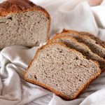 Slices of No Knead Strawberry Wheat Bread Loaf on white fabric