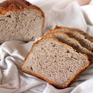 Slices of No Knead Strawberry Wheat Bread Loaf on white fabric