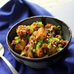 Keralan Tempeh Chili Roast in a black bowl on a blue cloth